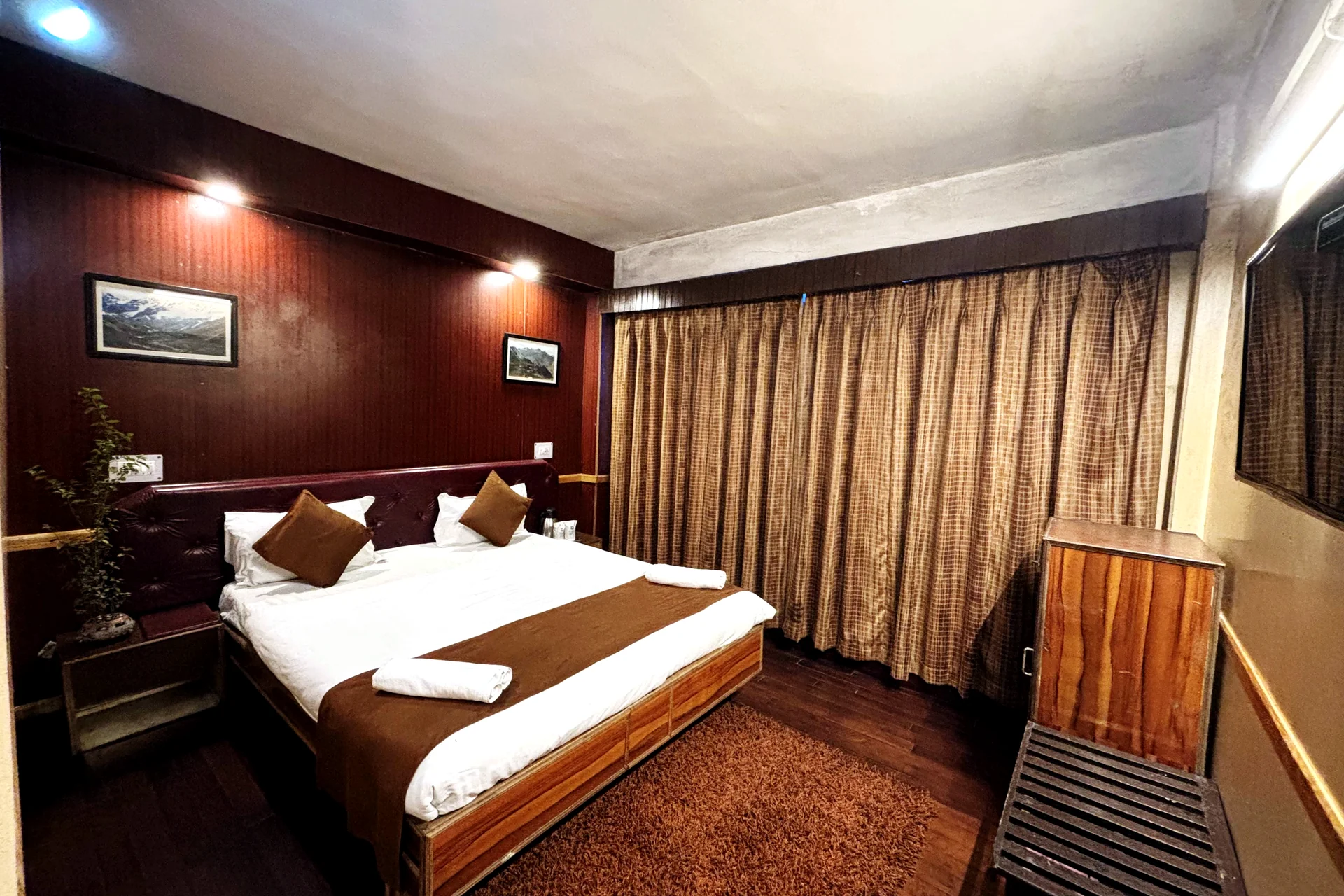 Deluxe Room at Hotel Apsara Darjeeling — wood-panelled bedroom