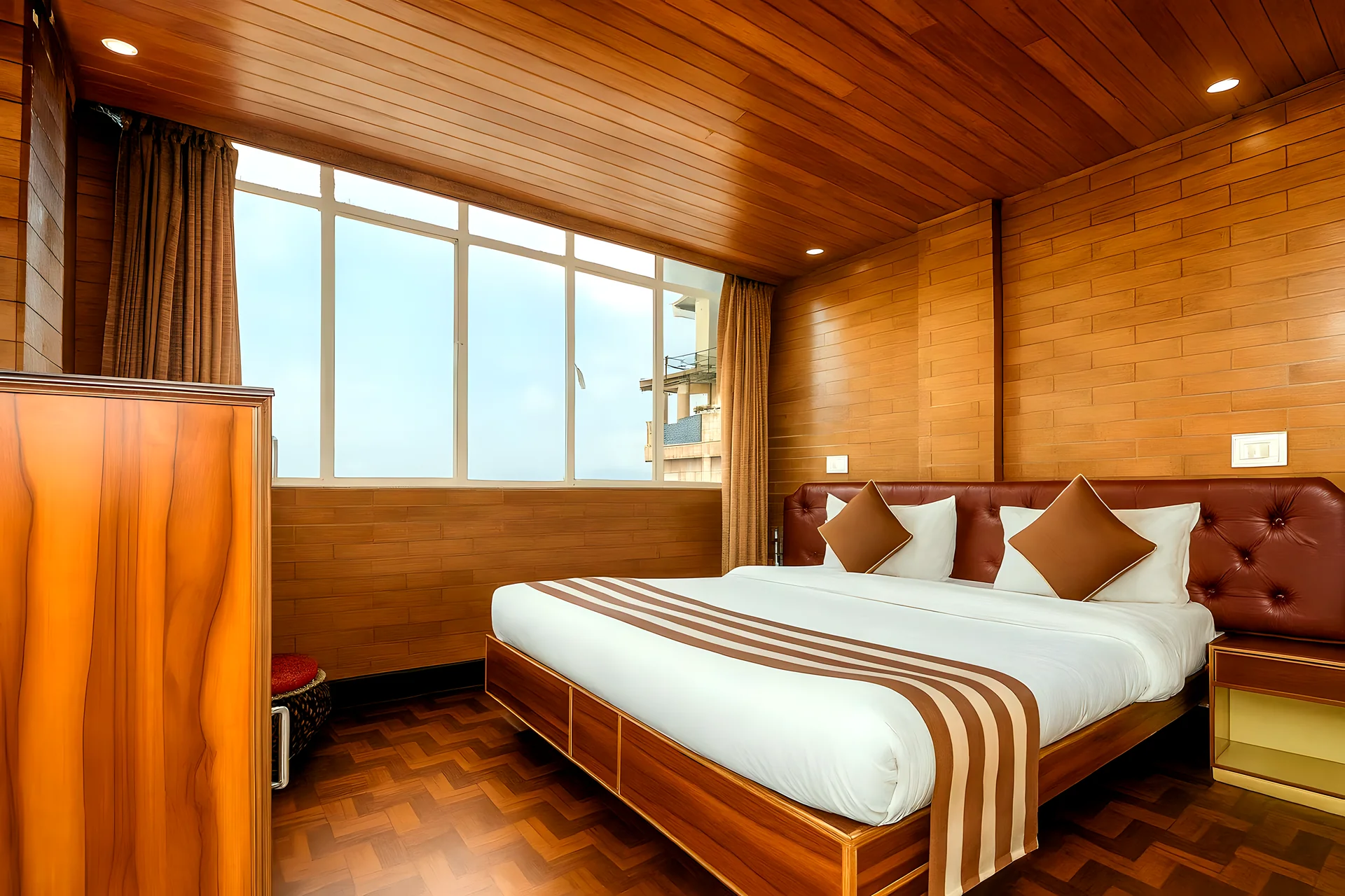 Deluxe Double Bedroom at Hotel Apsara Darjeeling with a mountain view, double bed — wood-panelled bedroom