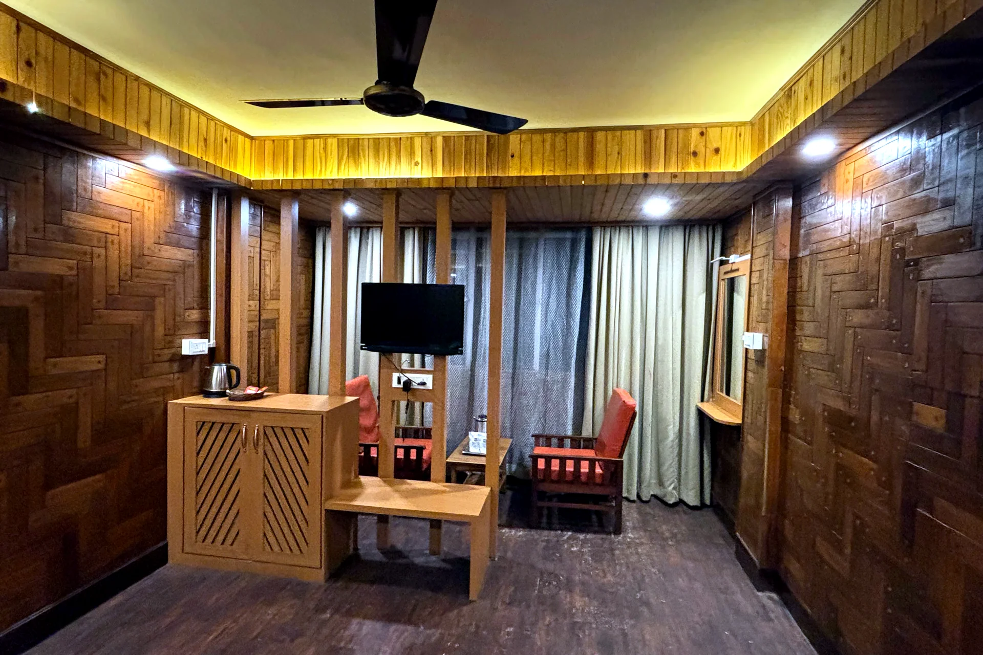 Super Deluxe Room with Mountain View at Hotel Apsara Darjeeling with a mountain view, king bed — wood-panelled bedroom