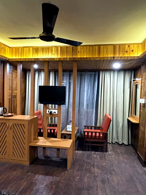 Super Deluxe Room with Mountain View at Hotel Apsara Darjeeling with a mountain view, king bed — wood-panelled bedroom