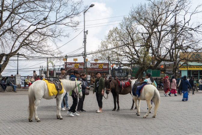 Chowrasta square in Darjeeling, with visitors walking across the paved pedestrian plaza