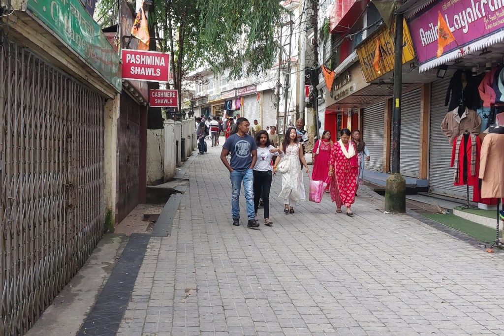 Mall Road in Darjeeling curving around the hillside, lined with buildings