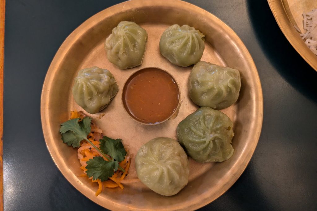 Vegetable momos served with tomato chutney